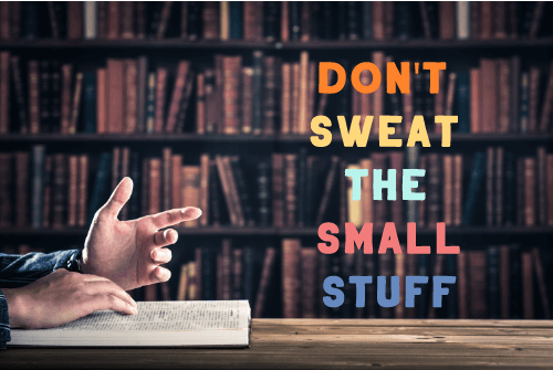 its a library and there is a hand on the book which is showing don't sweat the small stuff